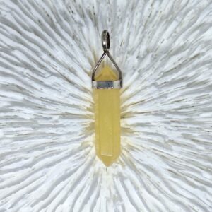 orange calcite pencil crystal pendant in a sterling silver casing